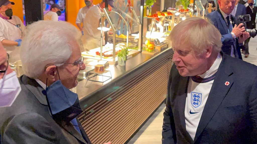 Boris Johnson wearing an England football shirt.