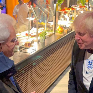 Boris Johnson wearing an England football shirt.