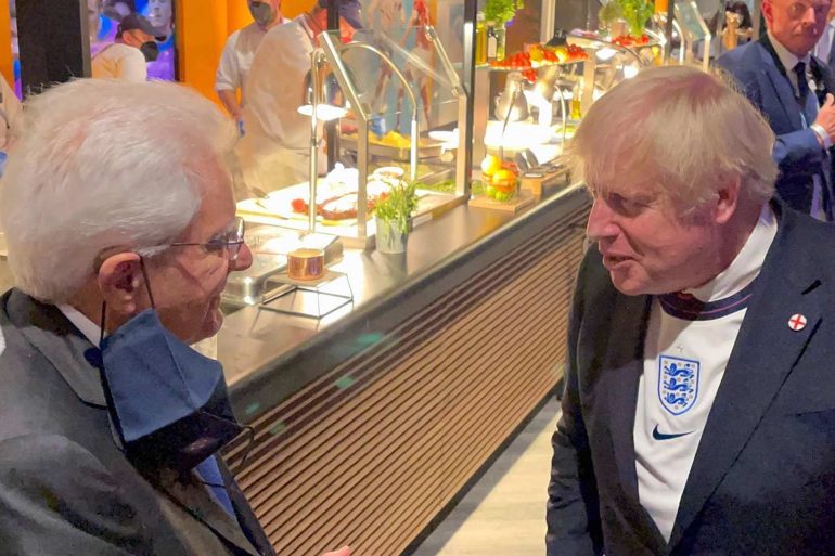 Boris Johnson wearing an England football shirt.