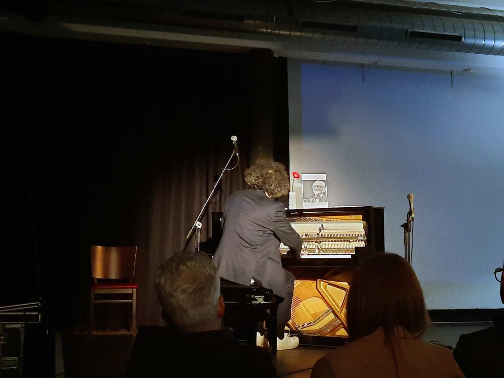 Men playing piano at the event.