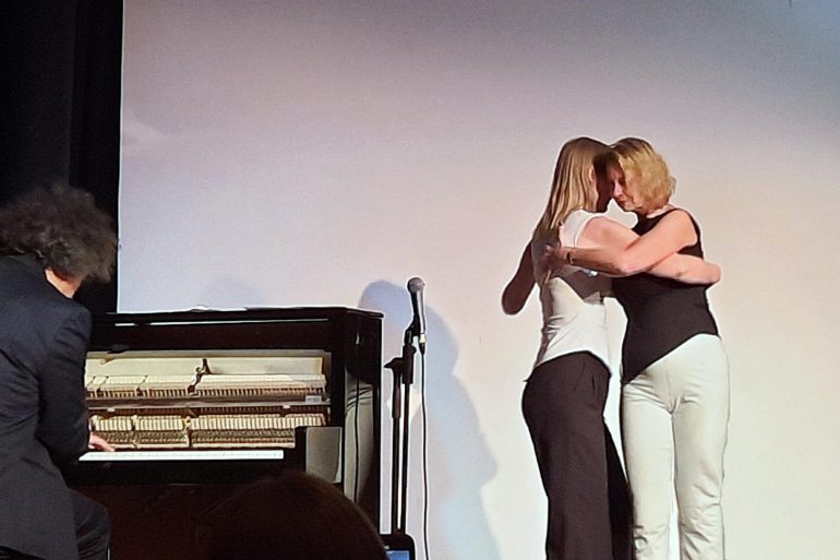 2 women doing the tango at the event.